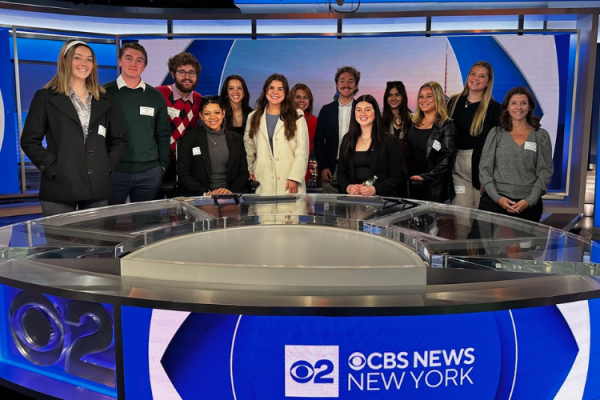 PRSSA students pose for photo in a news studio at CBS.